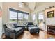 Cozy sitting area with comfortable chairs, a view of the outdoors, and access to the patio at 8392 Niwot Meadow Farm Rd, Niwot, CO 80503