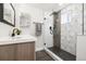 Modern bathroom featuring a glass enclosed shower with decorative tile and black fixtures at 7320 W 21St Ave, Lakewood, CO 80214