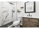 Modern bathroom with glass shower and sleek vanity, complemented by elegant fixtures at 7320 W 21St Ave, Lakewood, CO 80214