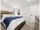 Bedroom featuring a wooden bed frame and two windows allowing for natural light at 7320 W 21St Ave, Lakewood, CO 80214