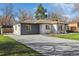 View of home's extension featuring a carport and long driveway at 7320 W 21St Ave, Lakewood, CO 80214