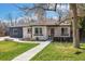 Charming single story home featuring a freshly manicured lawn, inviting front porch, and a tree with a backyard swing at 7320 W 21St Ave, Lakewood, CO 80214