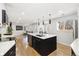 Bright kitchen features a large island with seating, stainless steel appliances, and an open layout at 7320 W 21St Ave, Lakewood, CO 80214
