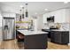 Modern kitchen with granite countertops, black and white cabinetry, stainless steel appliances, and a kitchen island at 7320 W 21St Ave, Lakewood, CO 80214
