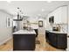Modern kitchen with granite countertops, black and white cabinetry, stainless steel appliances, and an island at 7320 W 21St Ave, Lakewood, CO 80214