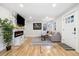 Bright living room with hardwood floors, a marble fireplace, and a comfortable couch at 7320 W 21St Ave, Lakewood, CO 80214