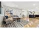 Bright living room featuring hardwood floors, comfortable seating and an open view to the kitchen at 7320 W 21St Ave, Lakewood, CO 80214