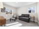Bright living room featuring neutral walls, carpeted floors, and a modern sofa at 7320 W 21St Ave, Lakewood, CO 80214