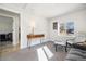 Cozy living room with bright light from a window showing wood floors and modern table at 7320 W 21St Ave, Lakewood, CO 80214