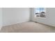 Carpeted bedroom with a window view of neighborhood homes and snow covered lawns at 9153 Truckee Ct, Commerce City, CO 80022