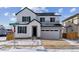 Beautiful two-story home featuring a two-car garage, and modern farmhouse design with white and gray accents at 9153 Truckee Ct, Commerce City, CO 80022