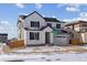 Charming two-story home with a modern farmhouse design, featuring a two-car garage and landscaped front yard at 9153 Truckee Ct, Commerce City, CO 80022