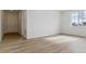 Inviting living room with hardwood floors, white walls, and a double door entrance at 9153 Truckee Ct, Commerce City, CO 80022