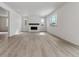 Bright and airy living room with hardwood floors, a cozy fireplace, and lots of natural light at 9153 Truckee Ct, Commerce City, CO 80022