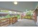 Covered back porch with wooden railing overlooking the backyard at 1740 S Estes St, Lakewood, CO 80232