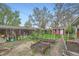 Backyard with garden beds, lush greenery, and a charming red shed at 1740 S Estes St, Lakewood, CO 80232