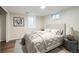 Basement bedroom with a queen bed, modern decor, and a window at 1740 S Estes St, Lakewood, CO 80232