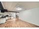 Basement features updated floors, shelves, lighting, and a kitchenette at 1740 S Estes St, Lakewood, CO 80232