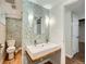 Bathroom features a large vanity, dual sinks, a mosaic tile wall, and updated lighting at 1740 S Estes St, Lakewood, CO 80232