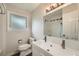 Bathroom with a new vanity, a large mirror, and a window for natural light at 1740 S Estes St, Lakewood, CO 80232