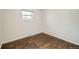 Cozy bedroom features hardwood floors, white trim, and a window at 1740 S Estes St, Lakewood, CO 80232
