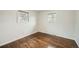 Bright bedroom features hardwood floors and natural light from two windows at 1740 S Estes St, Lakewood, CO 80232
