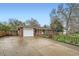 A single story brick home featuring an attached one car garage and a long, wide driveway at 1740 S Estes St, Lakewood, CO 80232