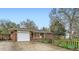 Charming single-story brick home featuring a well-maintained lawn, attached garage, and inviting curb appeal at 1740 S Estes St, Lakewood, CO 80232
