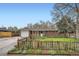 Charming brick home with well-manicured front yard, a cute fence, and inviting curb appeal at 1740 S Estes St, Lakewood, CO 80232