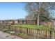 A charming brick home with well-kept lawn and a picket fence that adds to the property's appeal at 1740 S Estes St, Lakewood, CO 80232
