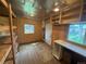 Unfinished interior featuring natural wood, open shelving, and a door to the exterior at 1740 S Estes St, Lakewood, CO 80232