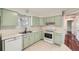Charming kitchen featuring ample counter space, and white appliances at 1740 S Estes St, Lakewood, CO 80232