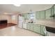 Well-lit kitchen next to the fireplace and featuring ample counter space at 1740 S Estes St, Lakewood, CO 80232