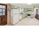 Bright kitchen featuring ample counter space, and white appliances at 1740 S Estes St, Lakewood, CO 80232