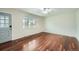 Bright living room with hardwood floors, large windows, and a stylish ceiling fan at 1740 S Estes St, Lakewood, CO 80232
