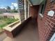 Inviting covered porch with decorative lattice and a charming brick facade at 1740 S Estes St, Lakewood, CO 80232