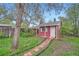 Quaint red shed in the backyard with a charming brick pathway at 1740 S Estes St, Lakewood, CO 80232