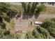 Aerial view of a home with ample parking space for cars, RVs, and trailers, surrounded by tall trees at 649 Cottonwood Dr, Evergreen, CO 80439