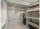 A basement closet provides secure and organized storage space with shelves and a rod for efficient home management at 649 Cottonwood Dr, Evergreen, CO 80439