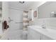 Bright bathroom showcases a vanity, shower-tub combo with grab bars, and neutral color palette for a serene feel at 649 Cottonwood Dr, Evergreen, CO 80439