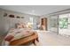 Well-lit bedroom with a decorative quilt, sliding doors to the deck, and cozy furnishings, offering a relaxing retreat at 649 Cottonwood Dr, Evergreen, CO 80439