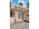 Close up of the entrance, showing hanging plants and a neutral color scheme, with flower pots on either side of the door at 649 Cottonwood Dr, Evergreen, CO 80439