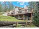 Exterior showcasing a home with multiple decks overlooking a picturesque wooded setting at 649 Cottonwood Dr, Evergreen, CO 80439
