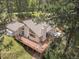 Aerial view of a charming home surrounded by lush greenery and a spacious wooden deck at 649 Cottonwood Dr, Evergreen, CO 80439