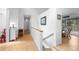 Bright hallway with hardwood floors and white walls leads to various rooms, providing an open and airy feel at 649 Cottonwood Dr, Evergreen, CO 80439