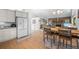 Inviting living space with a stone fireplace, wood floors, and an adjacent dining area for easy entertaining at 649 Cottonwood Dr, Evergreen, CO 80439