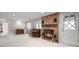 Cozy living room features a red brick fireplace, piano, and convenient wet bar at 649 Cottonwood Dr, Evergreen, CO 80439