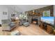 Comfortable living room showcasing a stone fireplace, hardwood floors, and a cozy seating area at 649 Cottonwood Dr, Evergreen, CO 80439