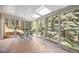 Charming sunroom with large windows overlooking lush greenery, perfect for enjoying nature indoors at 649 Cottonwood Dr, Evergreen, CO 80439