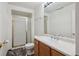 Bathroom with dark flooring featuring a shower with glass doors, a toilet, and a single sink vanity at 7852 S Addison Way, Aurora, CO 80016